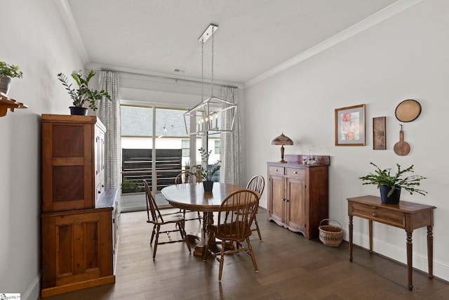 dining space with crown molding, wood finished floors, and baseboards