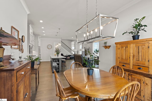 dining space with crown molding, wine cooler, stairs, recessed lighting, and wood finished floors