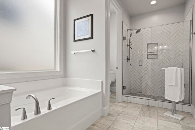 full bath featuring a shower stall, toilet, and a garden tub