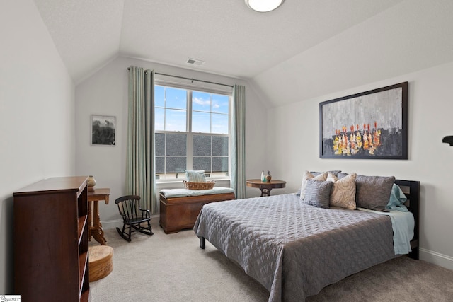 bedroom with visible vents, lofted ceiling, light colored carpet, and baseboards