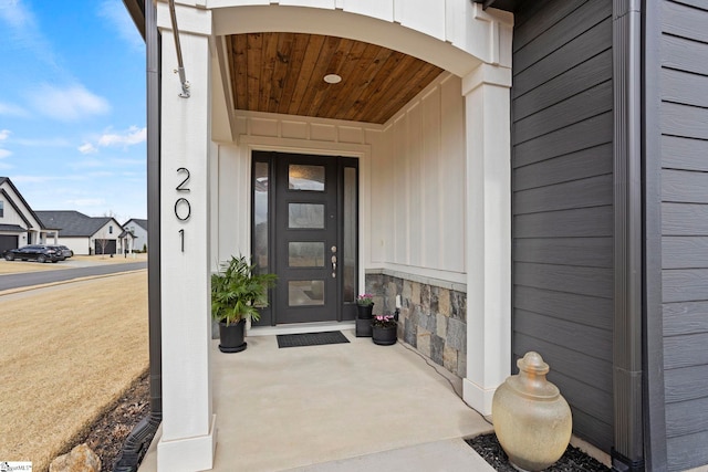 doorway to property featuring stone siding