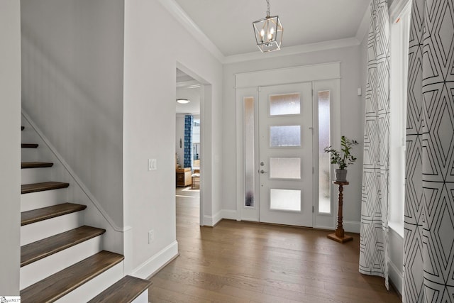 foyer with stairway, plenty of natural light, crown molding, and dark wood-style flooring