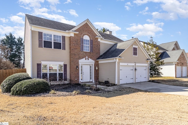 view of front of house featuring a shingled roof, concrete driveway, a chimney, fence, and brick siding