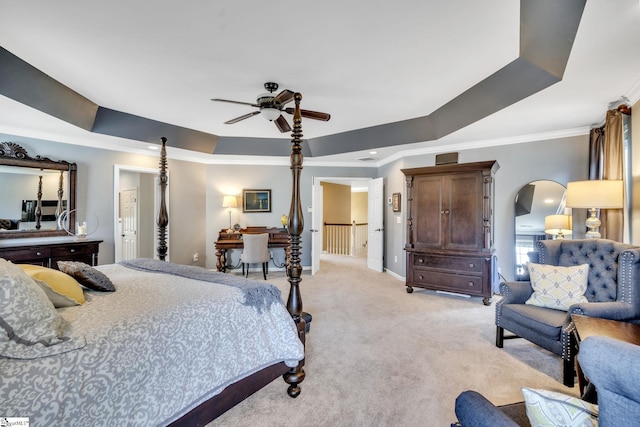 bedroom featuring a raised ceiling, light colored carpet, ornamental molding, a ceiling fan, and baseboards