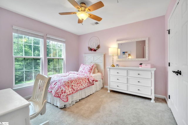 bedroom with baseboards, a ceiling fan, visible vents, and light colored carpet