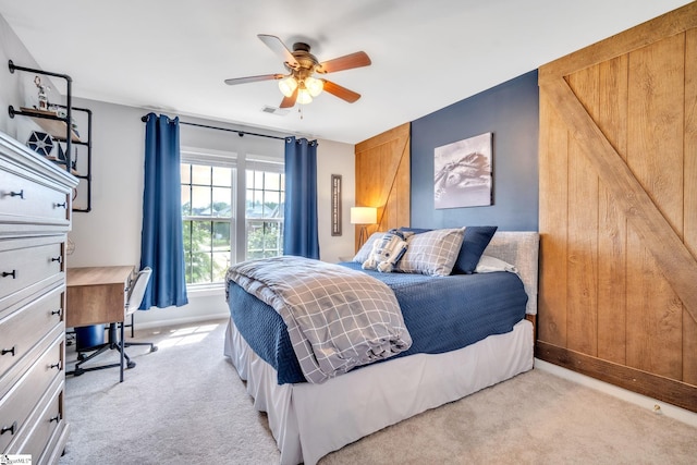 bedroom with light carpet, ceiling fan, visible vents, and baseboards