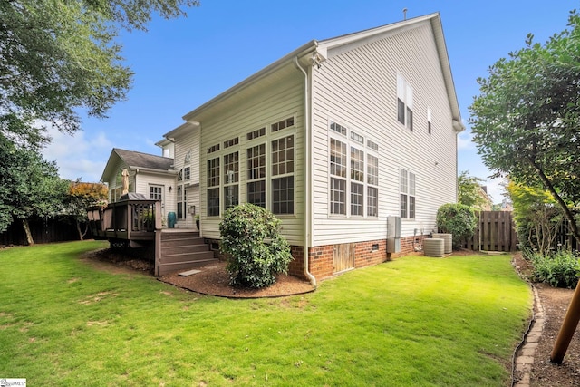 back of house with a wooden deck, central AC unit, crawl space, fence, and a yard