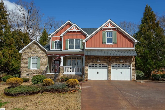 craftsman-style home featuring driveway, a porch, and board and batten siding