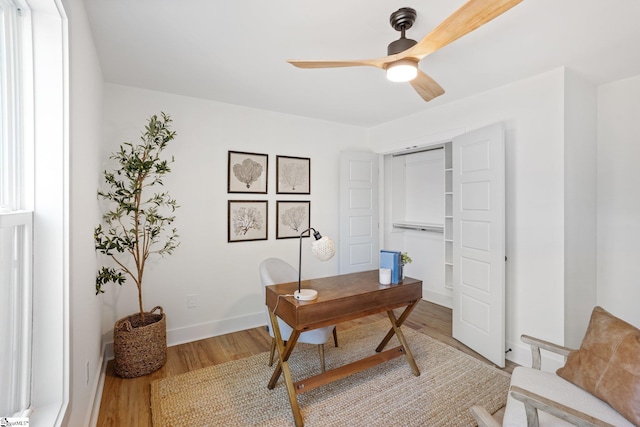 office with ceiling fan, baseboards, and wood finished floors