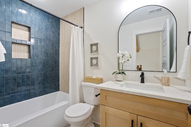 bathroom featuring toilet, visible vents, shower / tub combo with curtain, and vanity