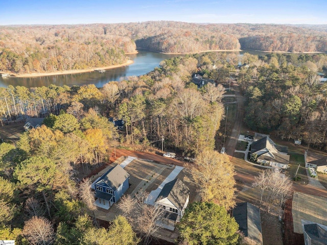 drone / aerial view featuring a forest view and a water view