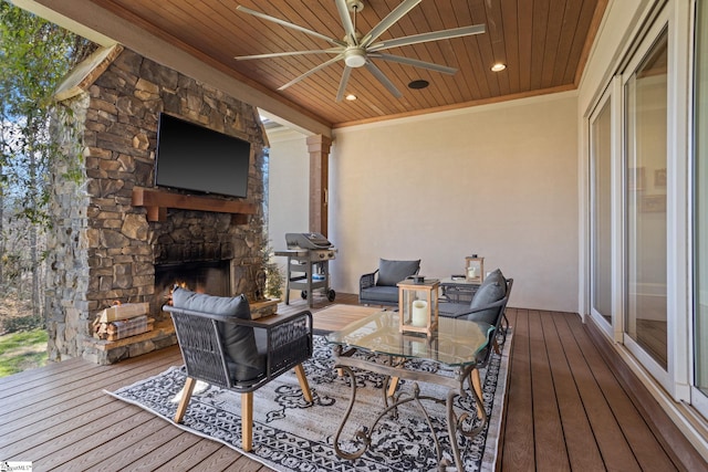 wooden terrace with ceiling fan, grilling area, and an outdoor living space with a fireplace