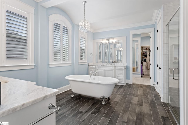 full bath with a notable chandelier, a spacious closet, a stall shower, wood tiled floor, and vanity