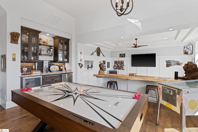 playroom featuring recessed lighting, visible vents, wet bar, wood-type flooring, and a raised ceiling