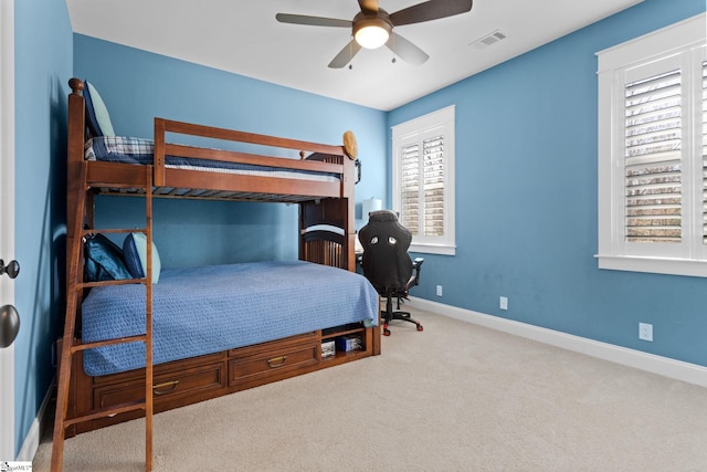 bedroom with baseboards, visible vents, ceiling fan, and carpet flooring