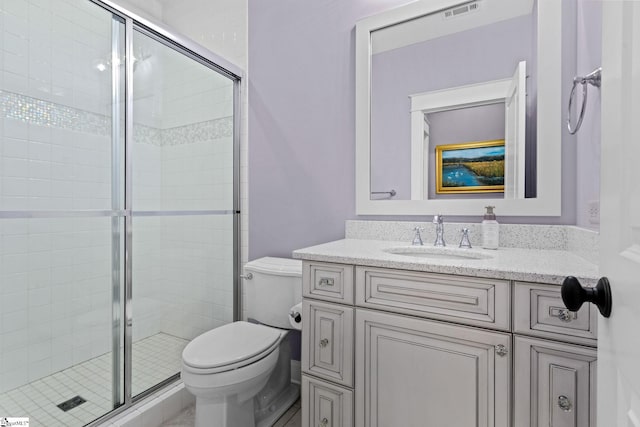 bathroom with a stall shower, visible vents, vanity, and toilet