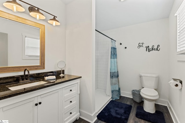 bathroom with a shower with curtain, vanity, toilet, and wood finished floors