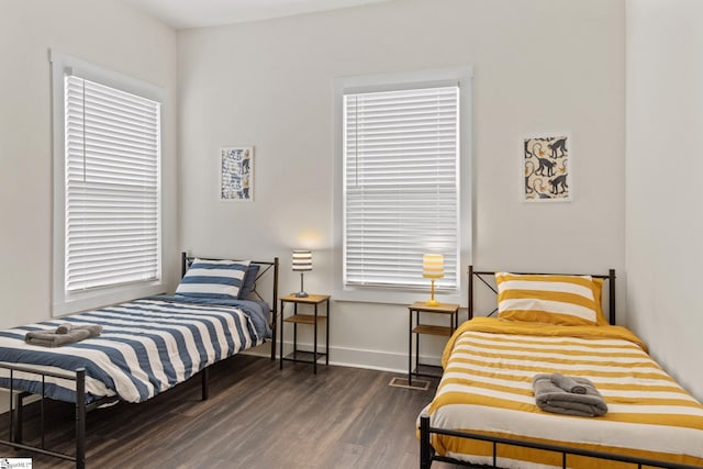 bedroom featuring baseboards and wood finished floors