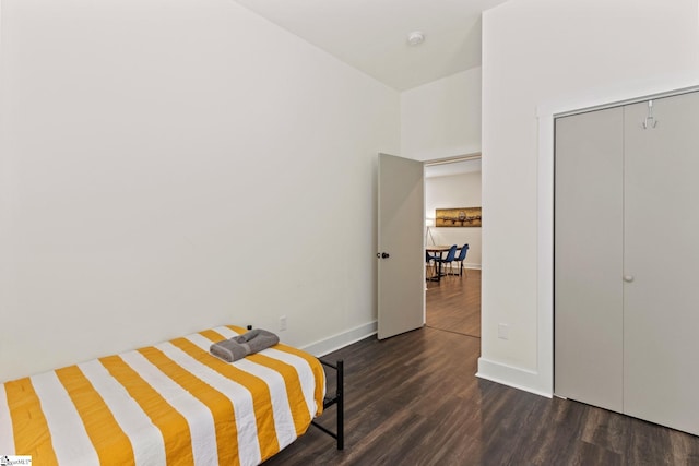 bedroom featuring dark wood-style floors and baseboards