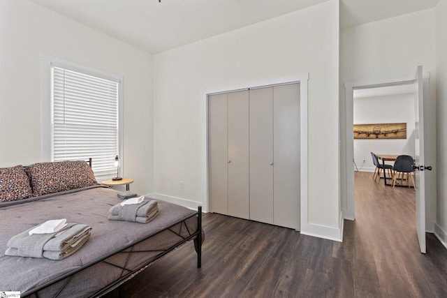 bedroom featuring dark wood-style flooring and baseboards