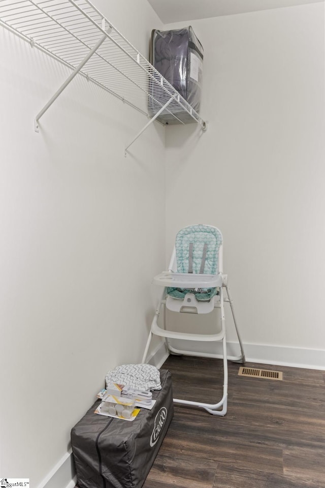 walk in closet featuring visible vents and wood finished floors