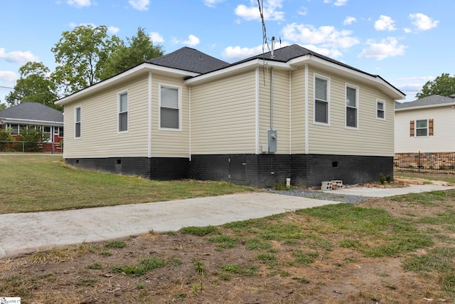 view of home's exterior with crawl space, a yard, and fence