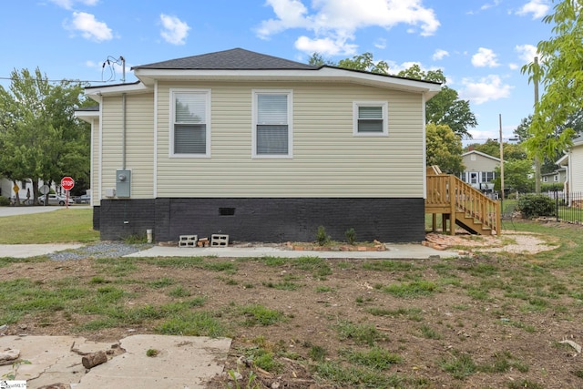 view of side of home featuring stairs