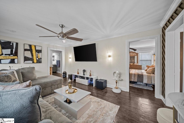 living room with ornamental molding, dark wood-type flooring, a ceiling fan, and baseboards