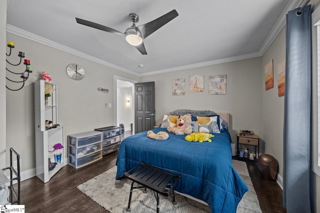 bedroom with dark wood-style floors, ornamental molding, baseboards, and a ceiling fan