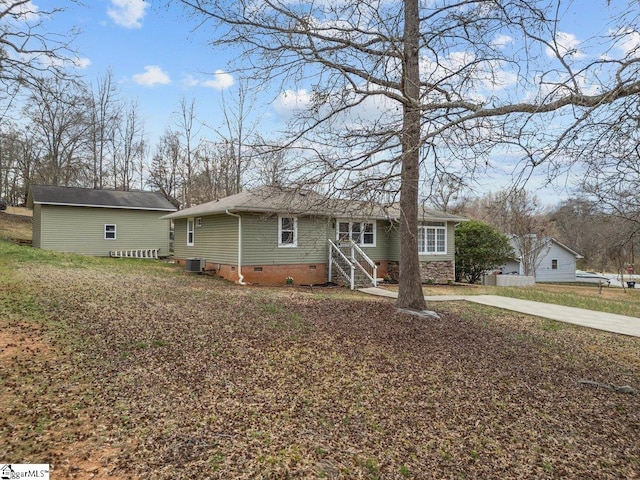 view of front of home with crawl space, driveway, and central AC