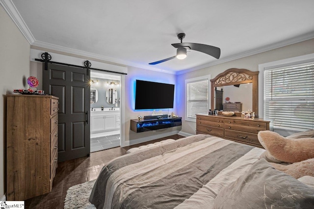 bedroom featuring a barn door, connected bathroom, wood finished floors, baseboards, and ornamental molding