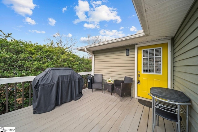 wooden deck featuring a grill