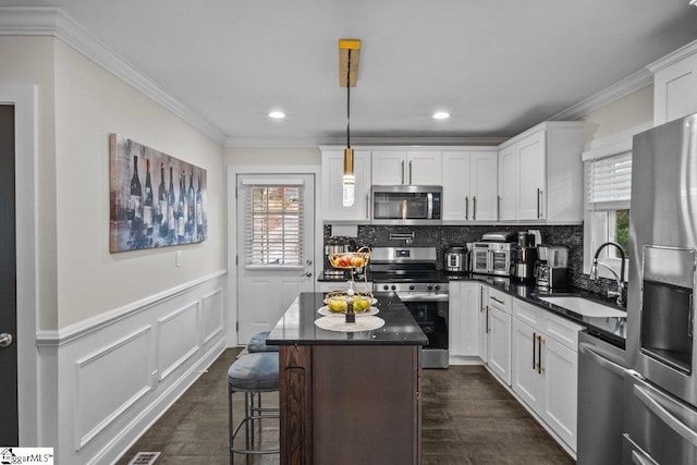 kitchen featuring plenty of natural light, appliances with stainless steel finishes, backsplash, and a sink