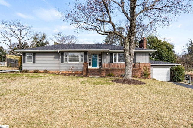 ranch-style home with an attached garage, a chimney, a front lawn, and brick siding