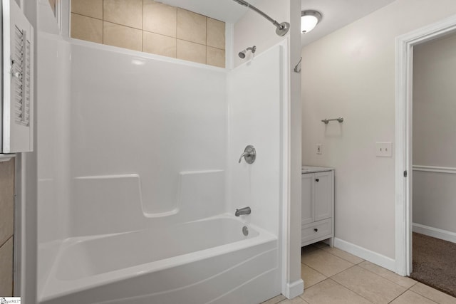 full bath featuring tile patterned flooring, bathtub / shower combination, and baseboards