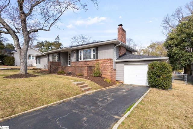 ranch-style house featuring aphalt driveway, a garage, brick siding, a front lawn, and a chimney