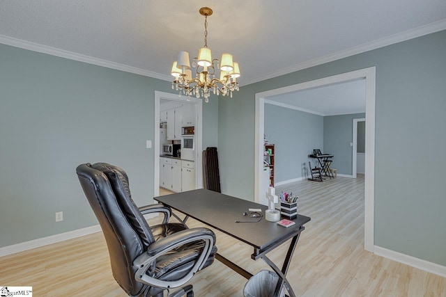 home office with light wood-style flooring, ornamental molding, and baseboards