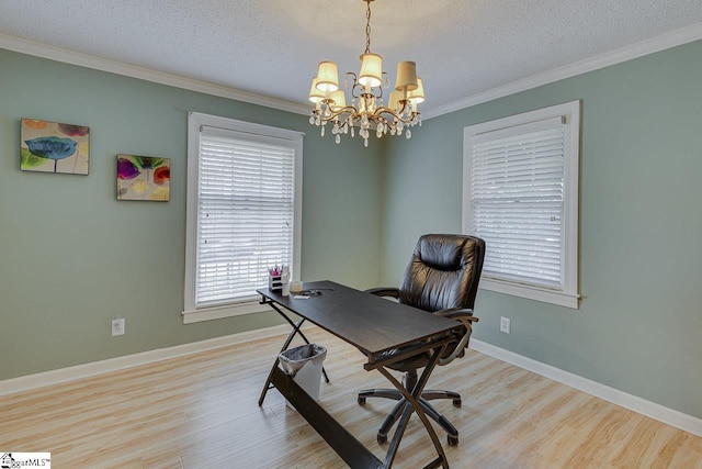 home office featuring light wood finished floors, ornamental molding, a textured ceiling, and baseboards