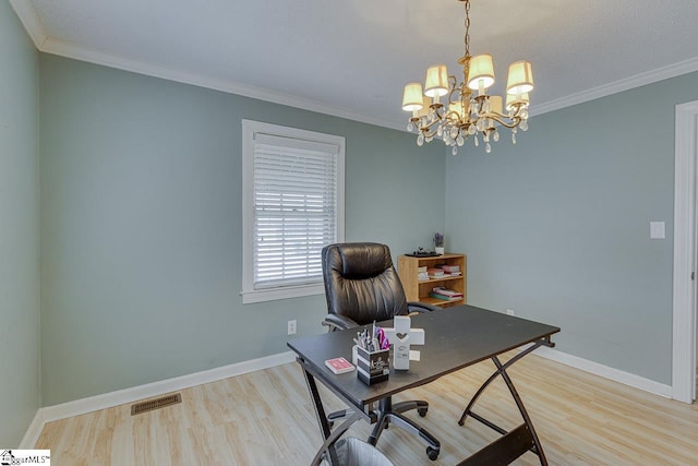 office area featuring light wood-style flooring, visible vents, and crown molding