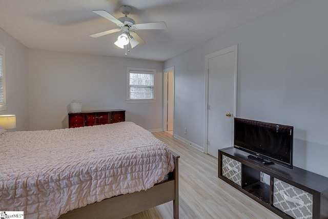 bedroom featuring ceiling fan, wood finished floors, and baseboards