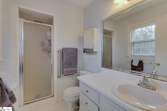 full bathroom featuring toilet, a shower stall, vanity, and tile patterned floors