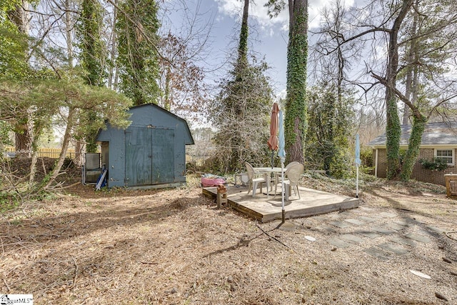 view of yard featuring a patio, a shed, and an outdoor structure