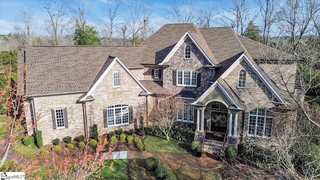 french provincial home featuring stone siding