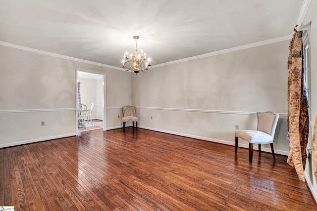 unfurnished room featuring a chandelier, wood-type flooring, ornamental molding, and baseboards