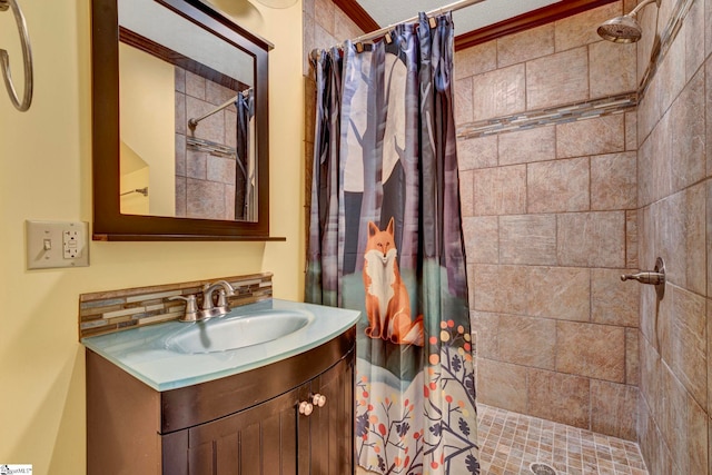 full bathroom with tiled shower and vanity