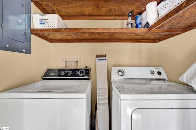 clothes washing area featuring laundry area, independent washer and dryer, and electric panel