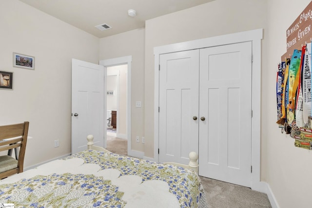 bedroom with light carpet, baseboards, visible vents, and a closet