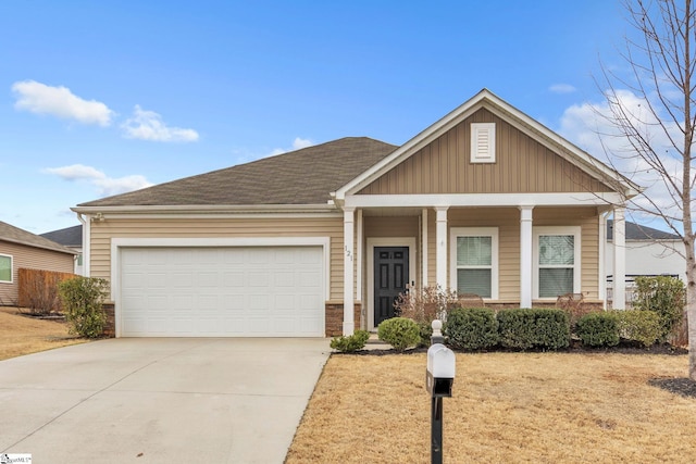 view of front of property featuring a shingled roof, driveway, an attached garage, and a porch