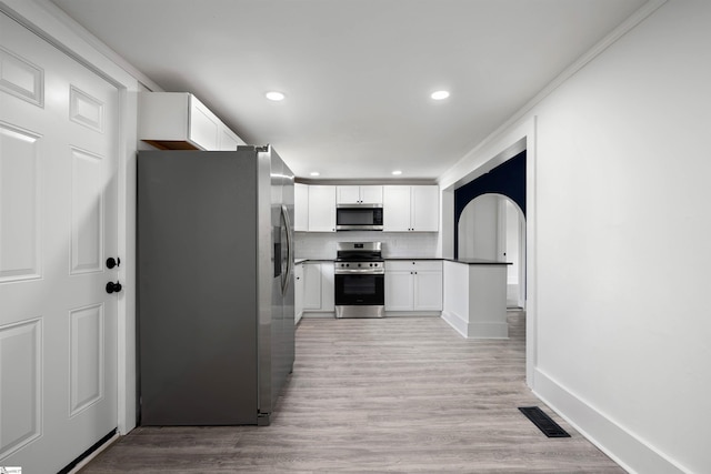 kitchen featuring light wood-type flooring, visible vents, appliances with stainless steel finishes, and tasteful backsplash