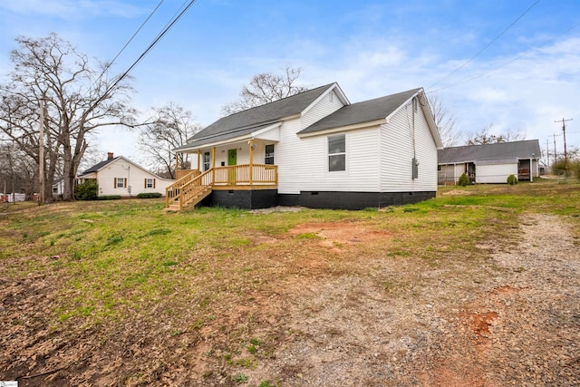 exterior space featuring roof with shingles, a porch, crawl space, and a front lawn